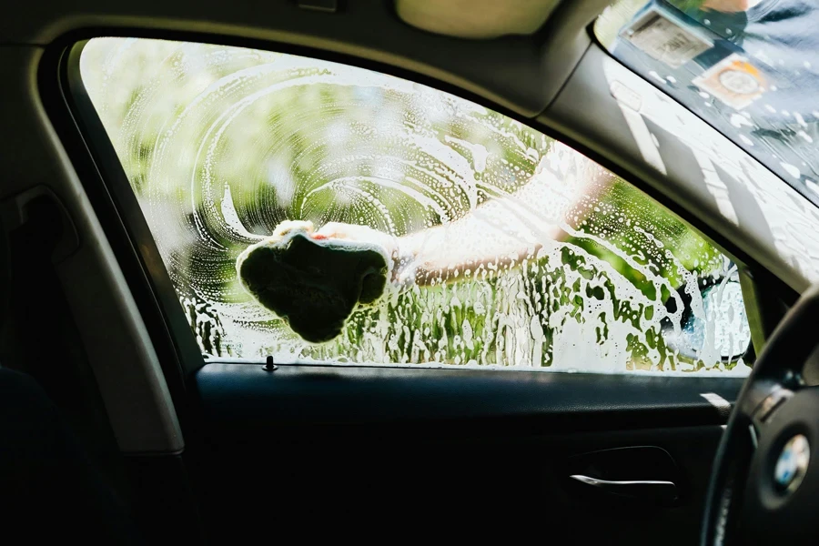 A Person Washing a Car Window