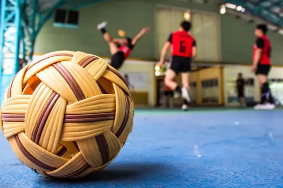 A Sepak takraw ball with players in the background