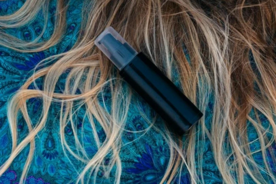 A bottle of hair loss concealer on long hair