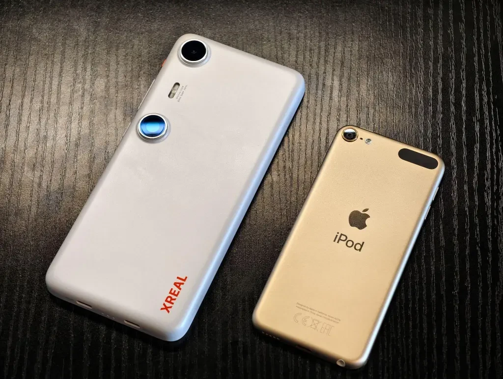 A close-up view of the XREAL Beam Pro device and the iPod Touch