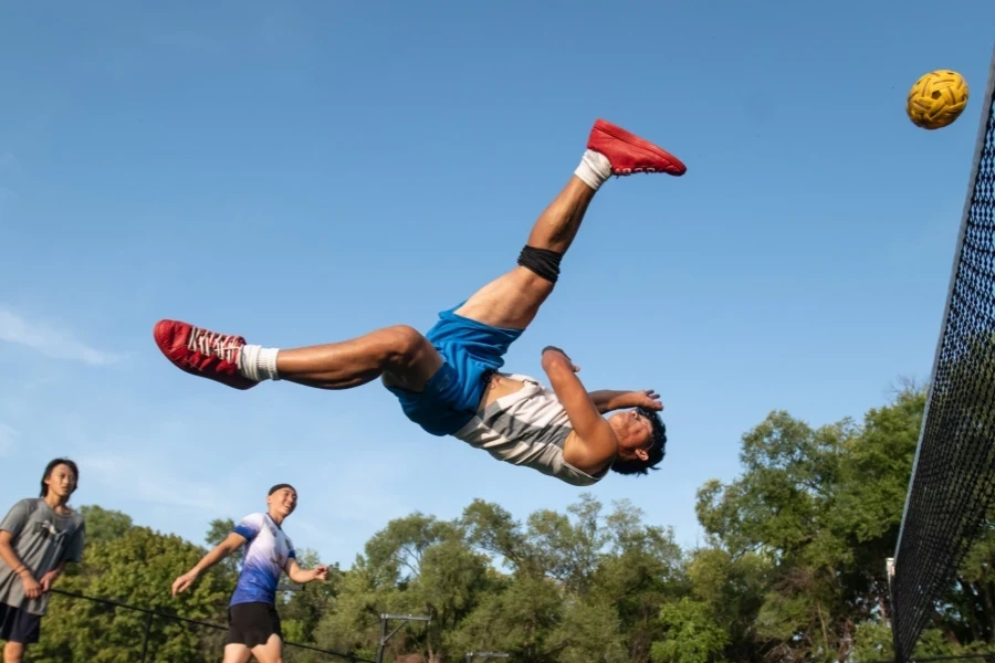 A fit man playing sepak takraw