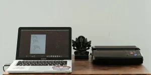 A laptop and printer on a table