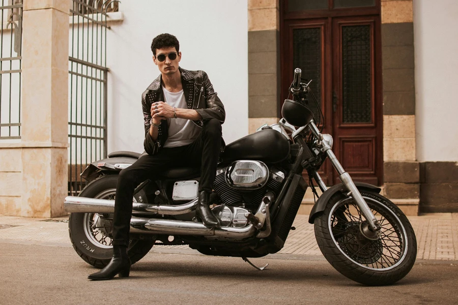 A man sitting on a motorcycle in front of a building