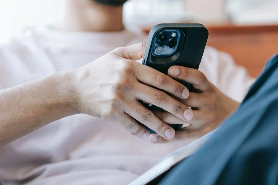 A man using a smartphone in a living room