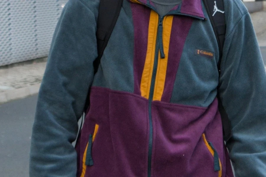 A man wearing a blue and orange microfleece jacket