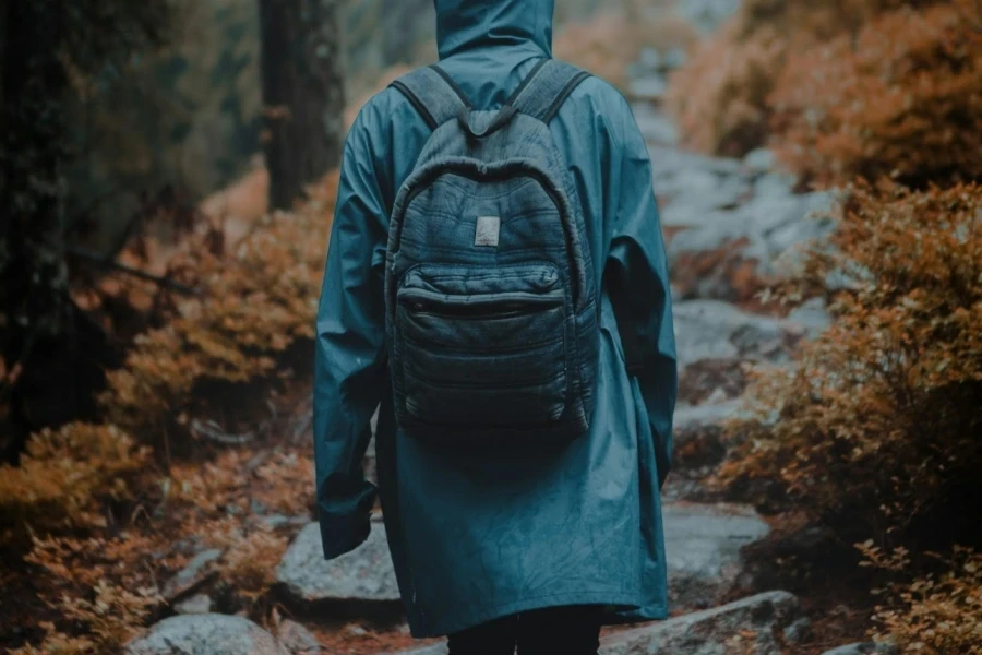 A person in a gray loose-fit rain jacket