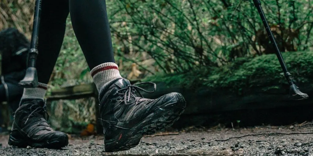 A person wearing black hiking shoes