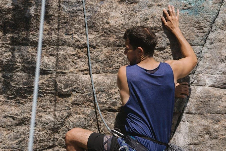 A rock climber holding on to ropes linked to a harness