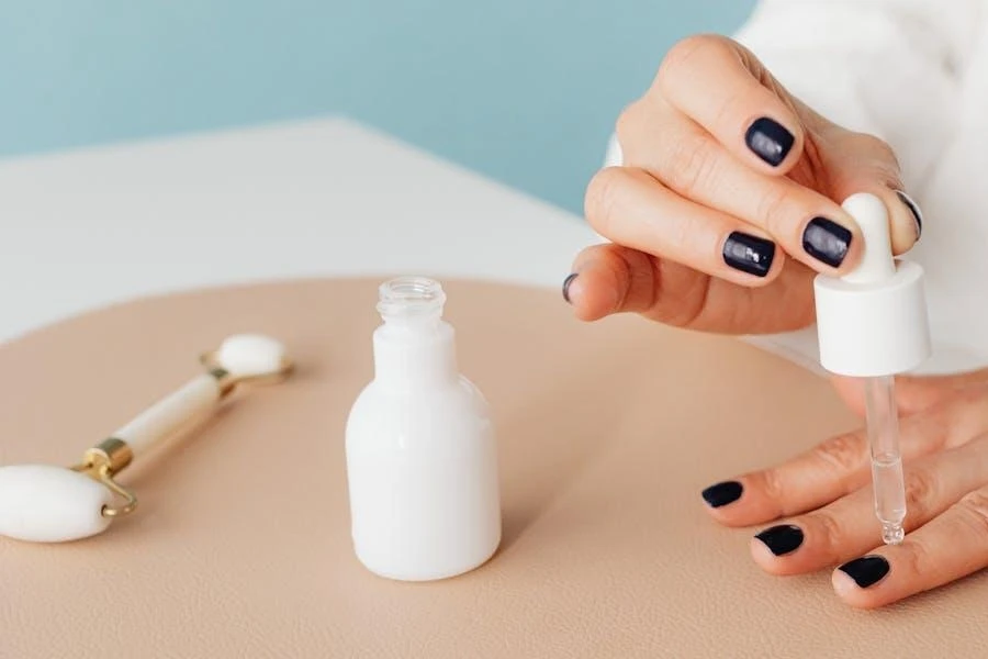 A woman applying oil to her nail cuticles