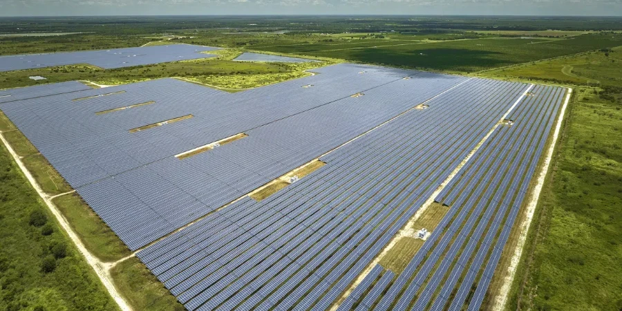 Aerial view of big sustainable electric power plant with many rows of solar photovoltaic panels for producing clean electrical energy. Renewable electricity with zero emission concept