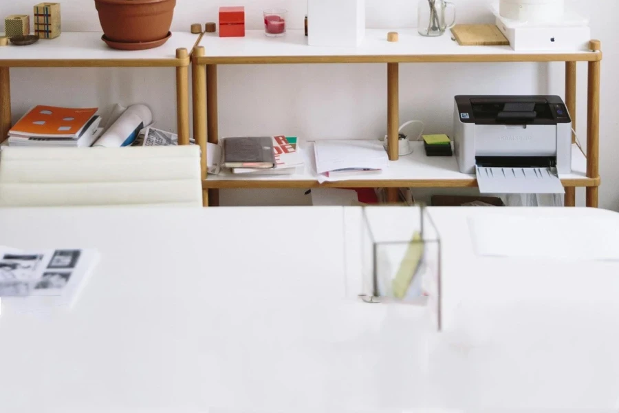 An inkjet printer on a workspace shelf