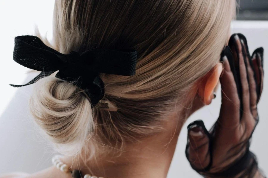 Back View of an Elegant Woman Wearing Pearl Jewelry and Mesh, Black Gloves