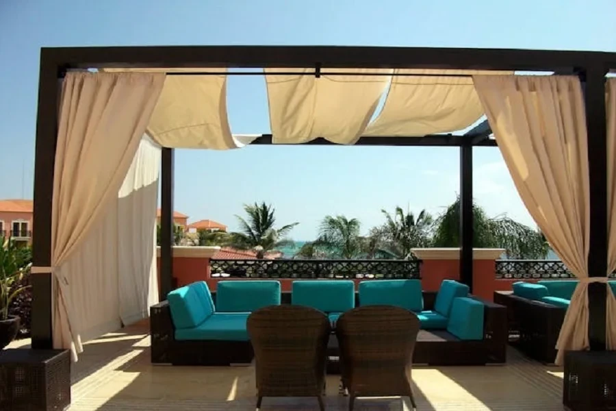 Blue and brown sofa with a canopy on a patio