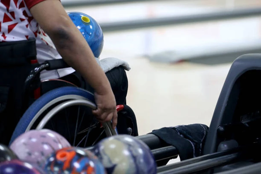 Bowler in wheelchair with bowling ball on their lap