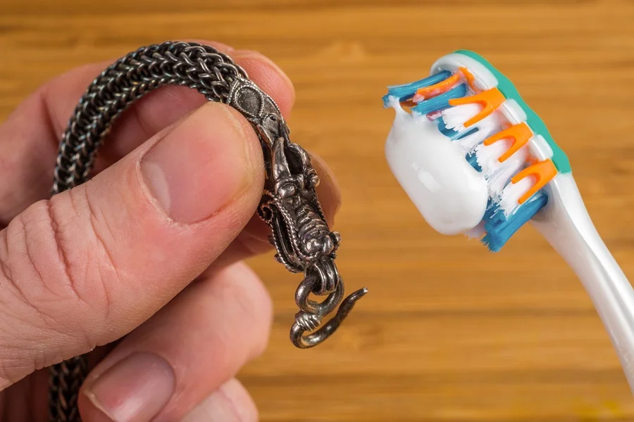 Cleaning silver jewelery with toothpaste and toothbrush