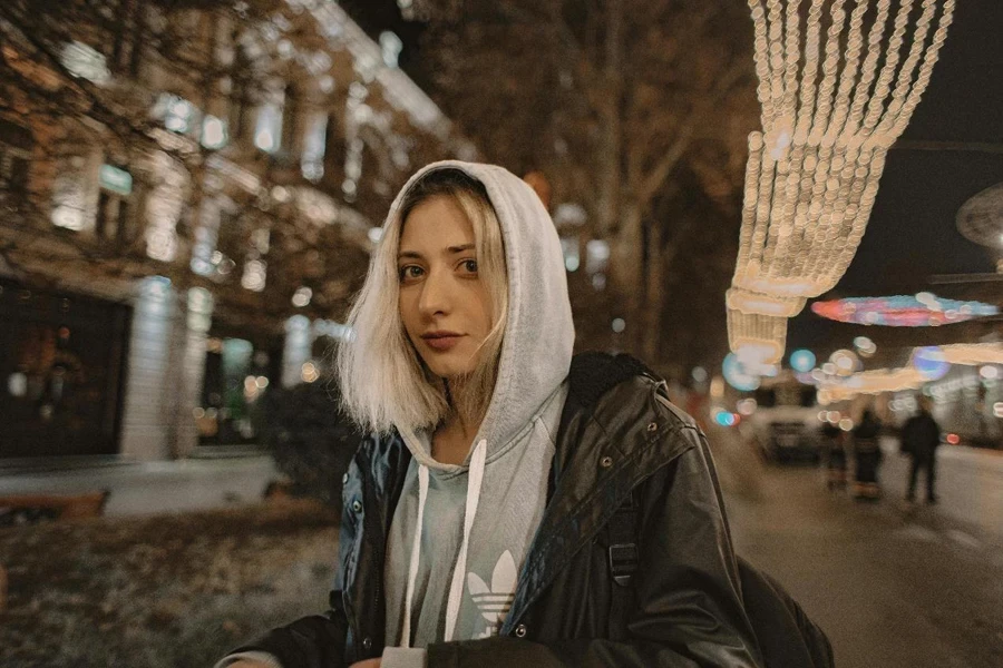 Close-up Of A Woman Wearing Black Zip-up Jacket Over A Gray Hoodie