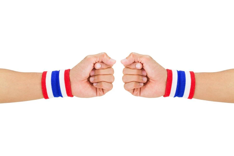 Color cloth wristbands on the guy's wrists on white background