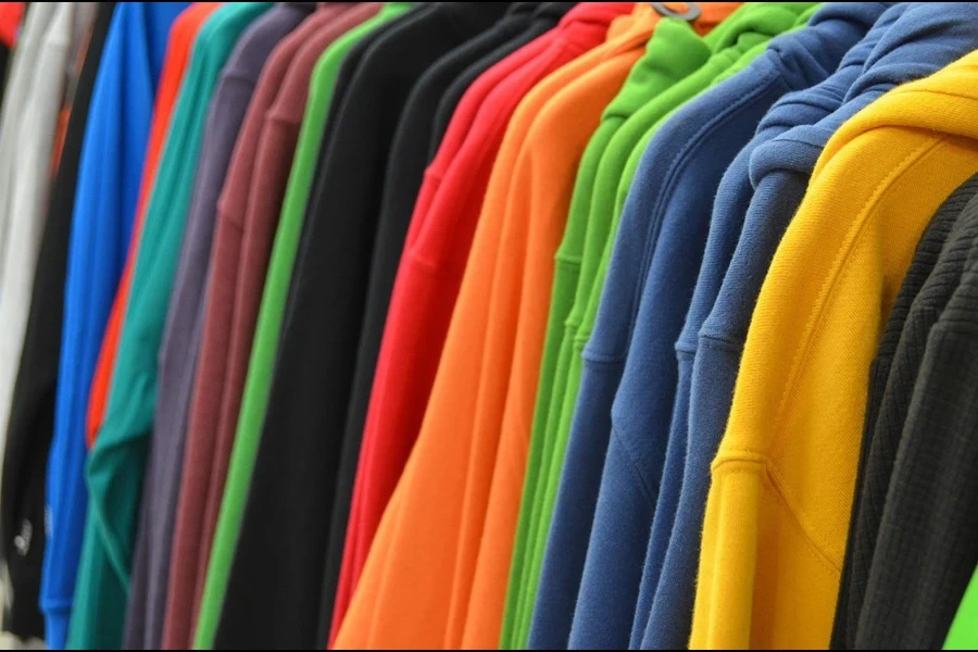 Colorful sweatshirts lined up on a rack