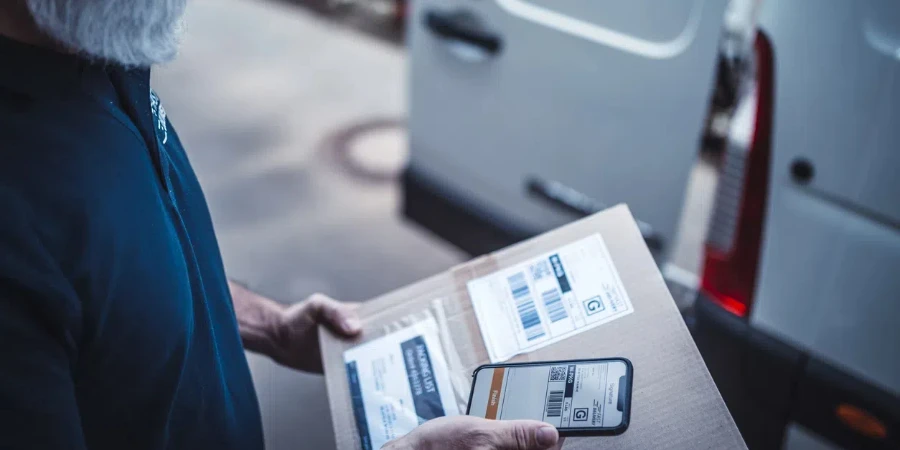 Delivery man scanning barcode on a package label