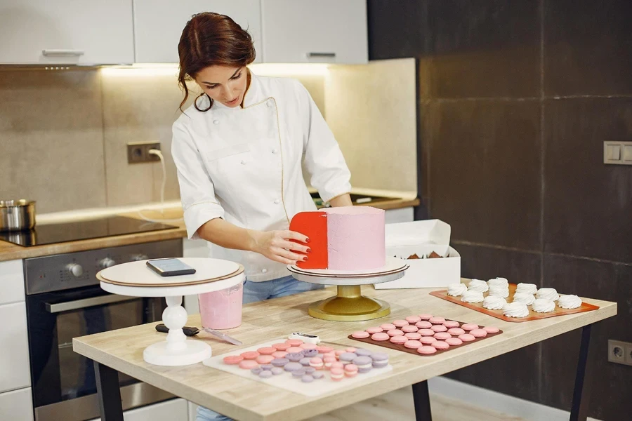 Female pastry chef preparing cake and desserts