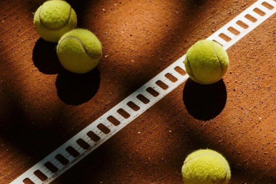 Four tennis balls on tennis clay court