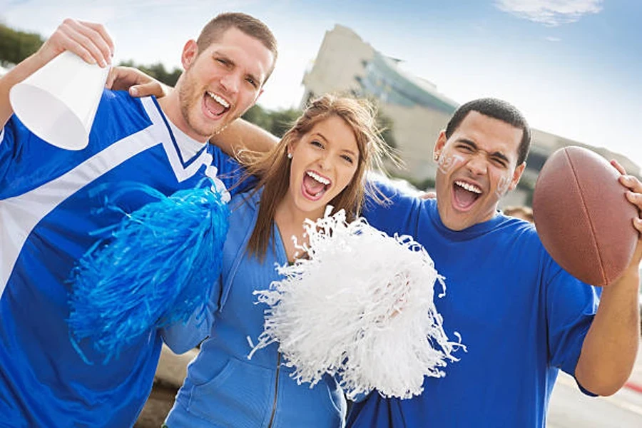 Friends holding pom poms and a mini plastic megaphone