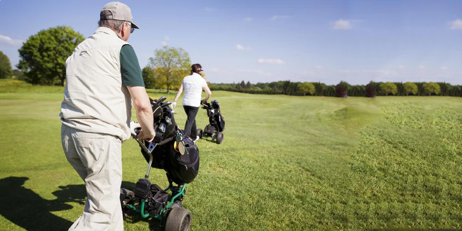 Gold couple walking on fairway with bags