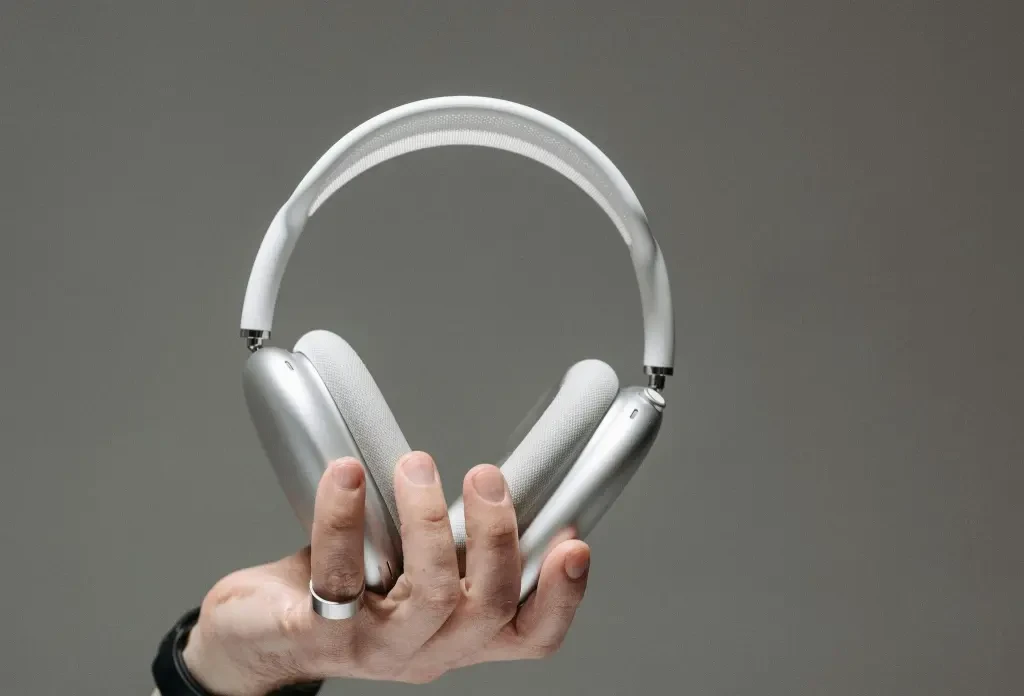 Hand Holding a White Wireless Headphones, AirPods Max