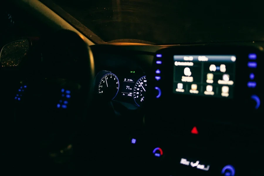 Illuminated dashboard of contemporary car parked on street in evening