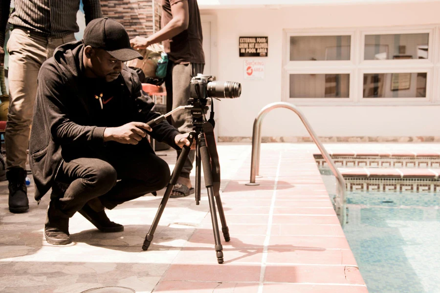 Man Looking at Camera on Tripod