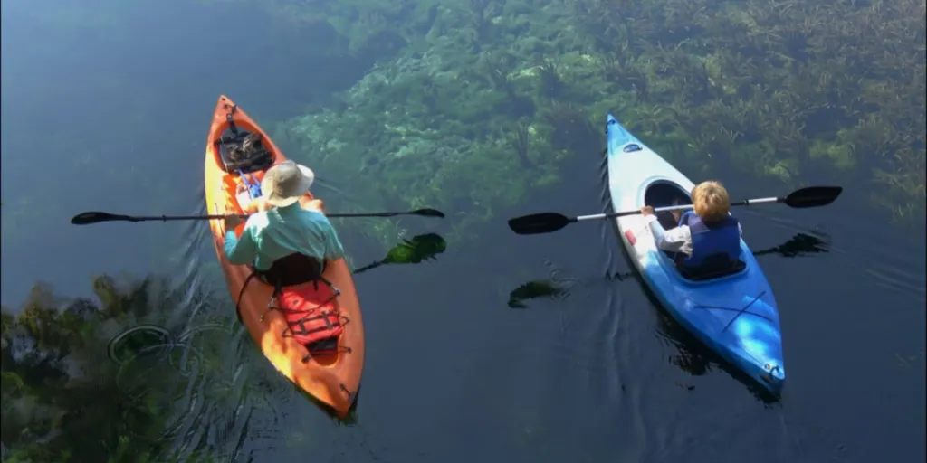 Man and son in kayaks with kayaking dry bags