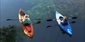 Man and son in kayaks with kayaking dry bags