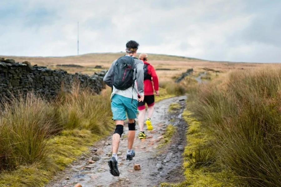 Man day hiking in trail running shoes