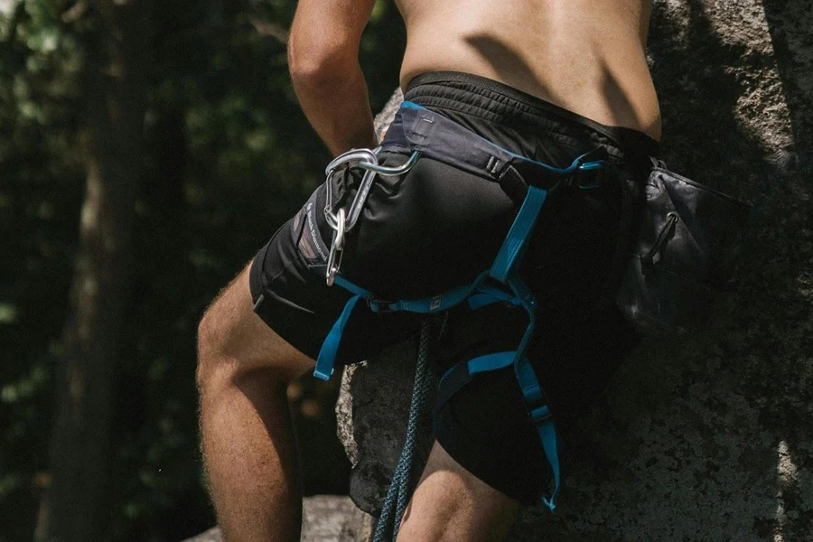 Man descending with a blue lightweight harness