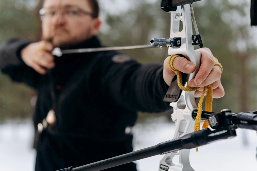 Man in Black Jacket Aiming While Holding Bow