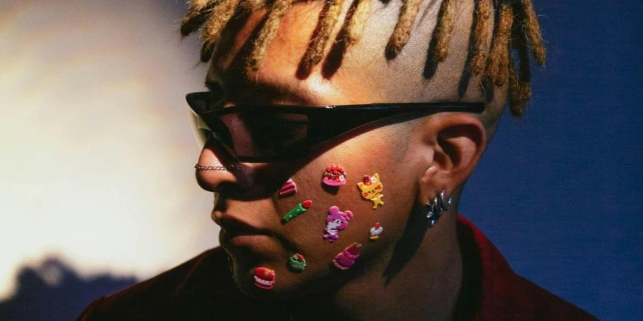 Man in Dreadlocks with Stickers on His Cheek