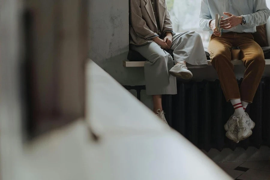 Man in Gray Suit Jacket Sitting on White Bench