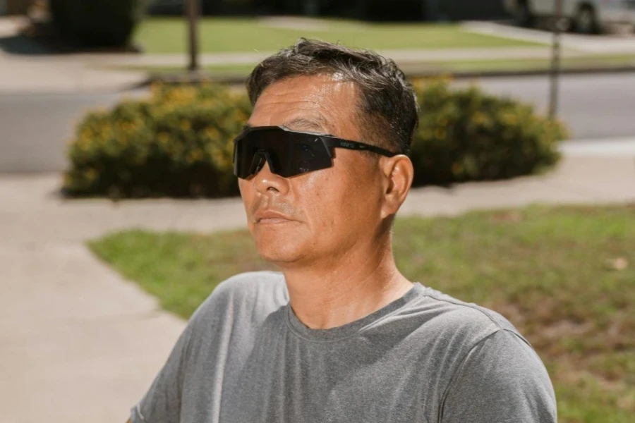 Man in T-shirt and Sunglasses Sitting on Chair