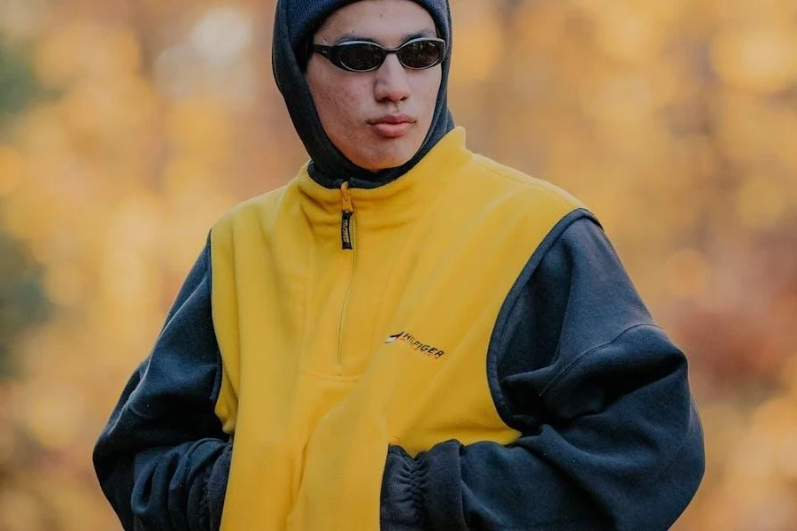 Man in a yellow bomber jacket and beanie