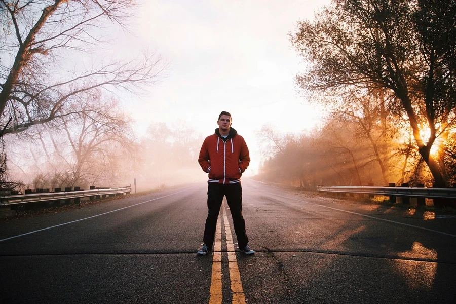 Man on the road wearing a hoodie