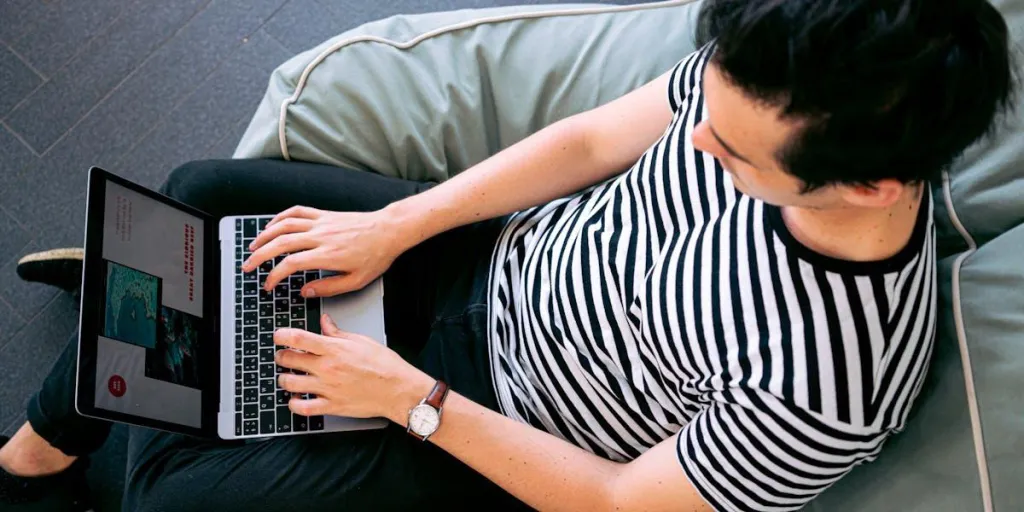 Man writing a blog while sitting on a couch