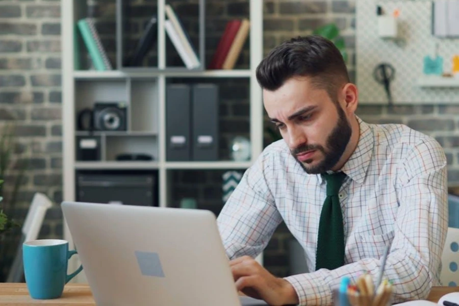 Man writing on his laptop