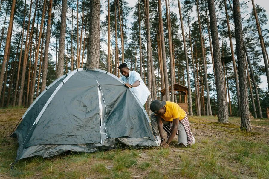 Men setting up camp tents