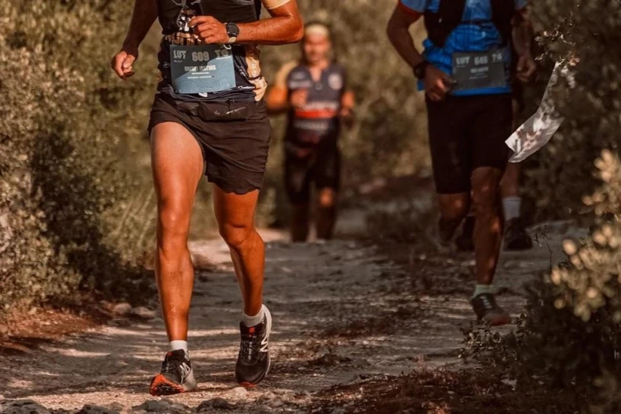 People trail running on a technical terrain