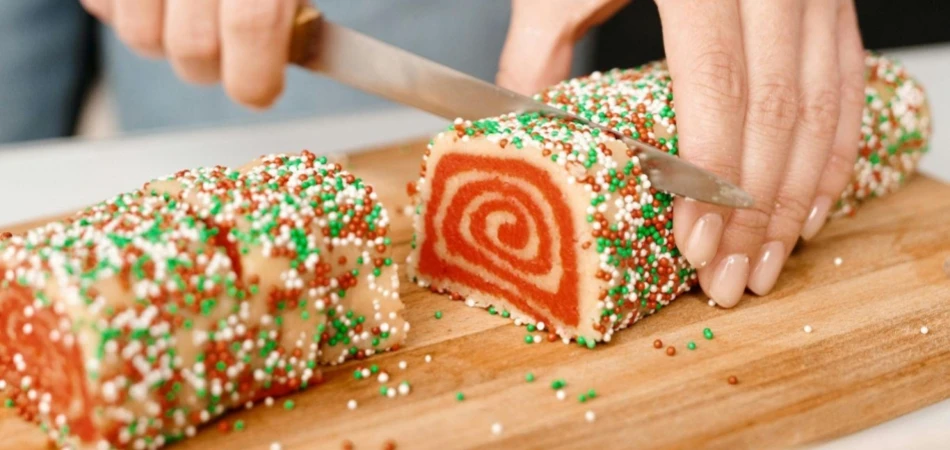 Person Slicing a Cake into Pieces