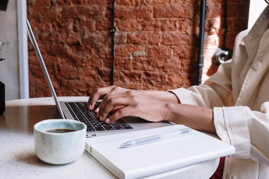 Person writing on a laptop