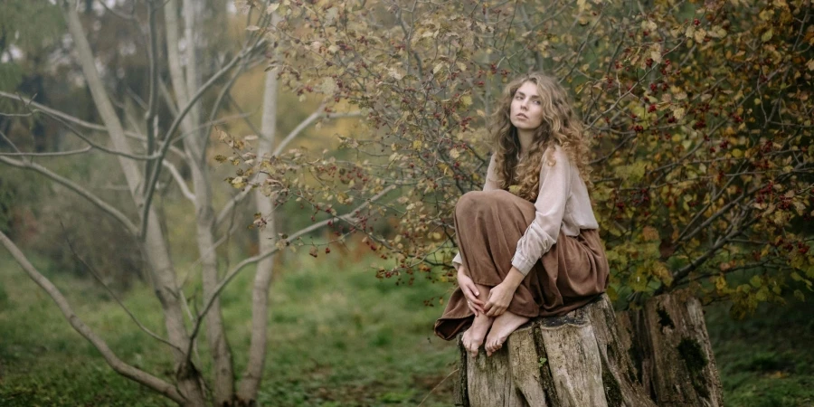 Photo Of Woman Sitting On Wood