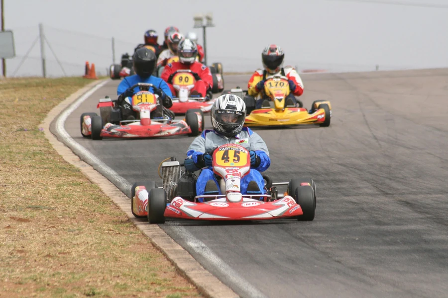 Racers with Helmets Driving Fast