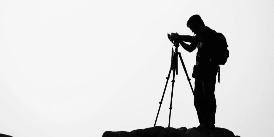 Silhouette of Man Holding Camera