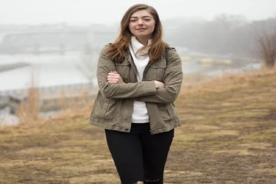 Smiling lady in a barn jacket and skinny jeans